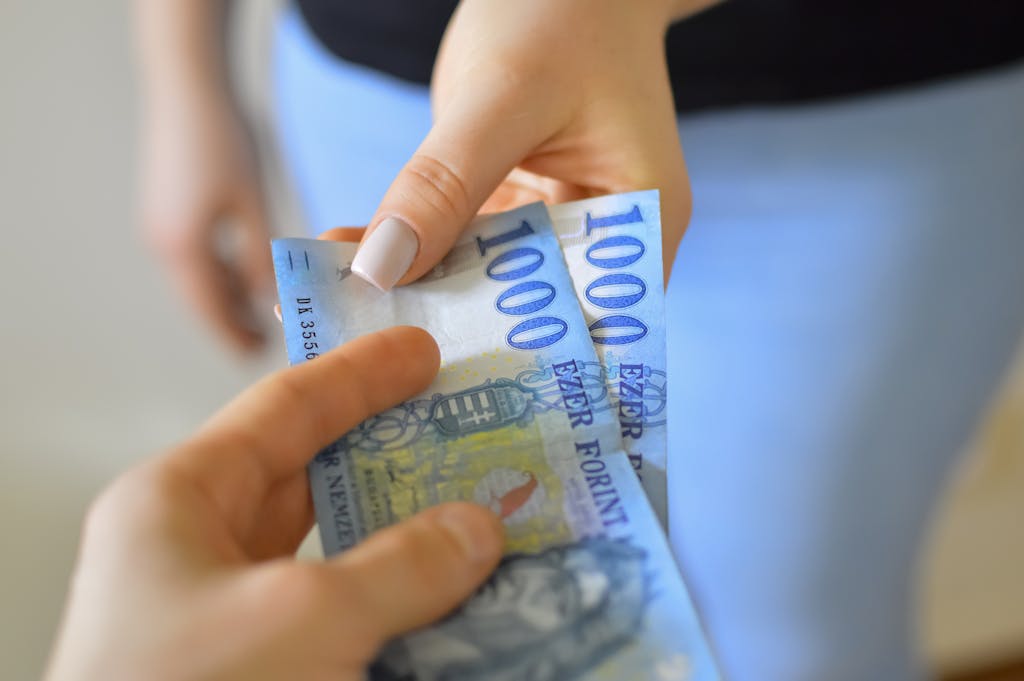 Closeup of Hands Holding Banknotes